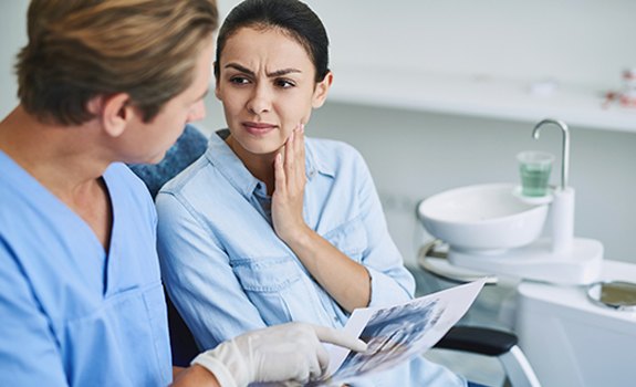 Emergency dentist in Lakewood, Dallas, speaking with a patient