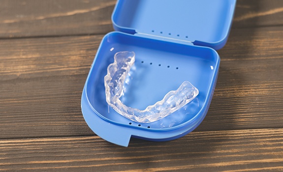A nightguard placed inside a protective case