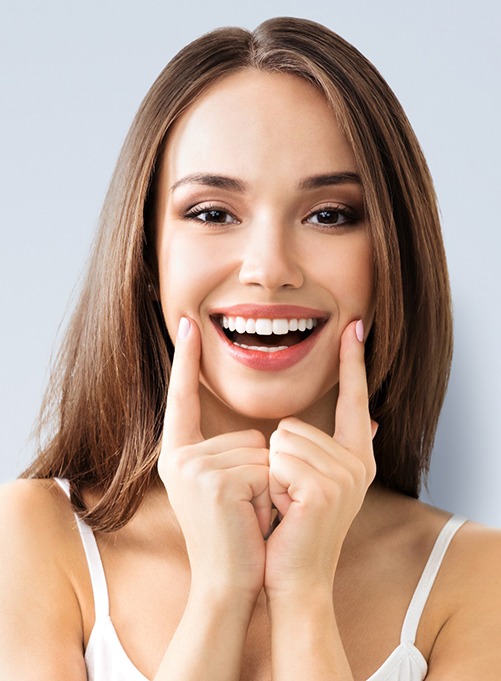 a woman smiling after a dental checkup and cleaning