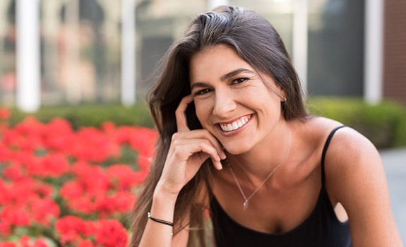A woman showing off her new and improved smile thanks to dental bonding in Lakewood