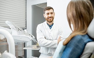 dentist explaining alternative tooth-replacement options to patient 