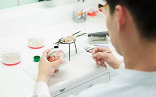 a dental technician working on creating dentures