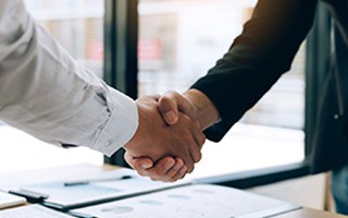 Two people shaking each other’s hands