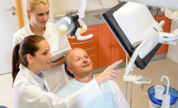 Male dental patient learning about his treatment options