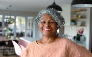 Woman smiling with dental implants in Lakewood