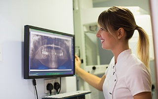 Implant dentist in Lakewood viewing a dental X-ray.