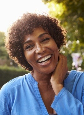 Woman sharing smile after replacing missing teeth