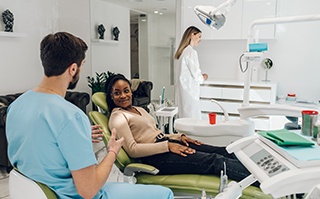 Invisalign patient in Dallas smiling at dentist