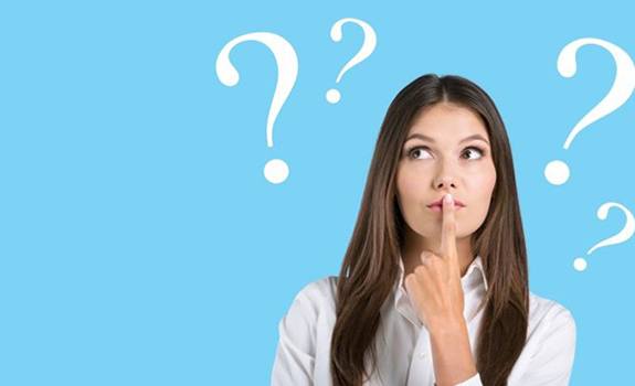 Pondering woman with question marks has questions for Lakewood dentist