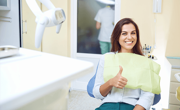 Smiling woman after seeing a sedation dentist