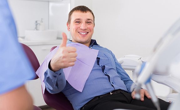 Relaxed man gives thumbs up to his sedation dentist 
