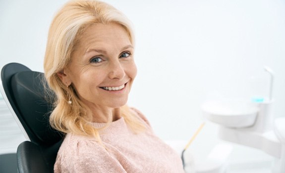 a patient smiling after receiving her dental implants in Lakewood