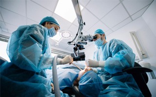 an oral surgeon performing the dental implant placement procedure