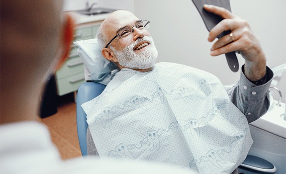 Woman holding cheek during root canal treatment appointment