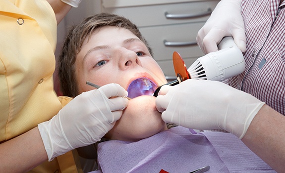a boy receiving a dental sealant