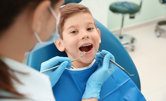 a child smiling during a dental appointment