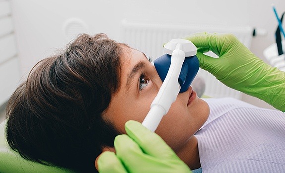 Dental team member placing nitrous oxide dental sedation mask