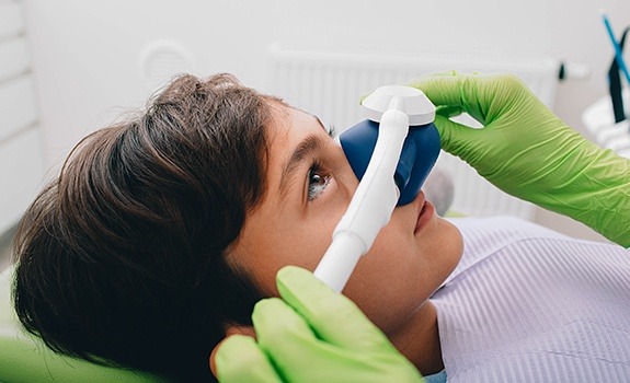 Dental team member placing nitrous oxide dental sedation mask