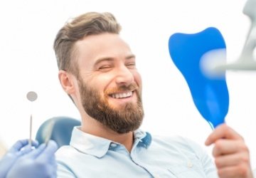 Man looking at smile during dental checkup