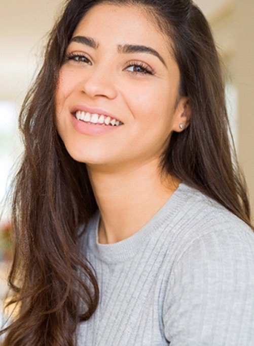 young woman smiling after getting teeth whitening in Dallas