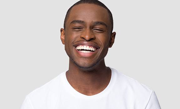 Laughing man with beautiful smile thanks to veneers in Lakewood