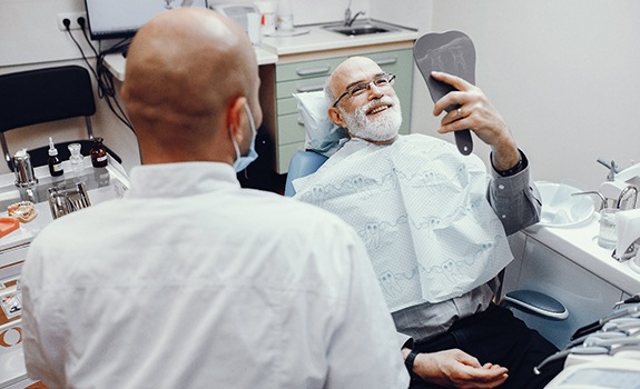 Patient viewing their veneers in Lakewood with a dentist.