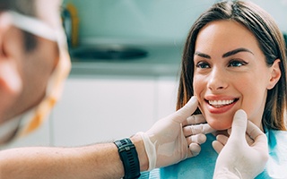 A cosmetic dentist in Lakewood examining a patient’s smile.