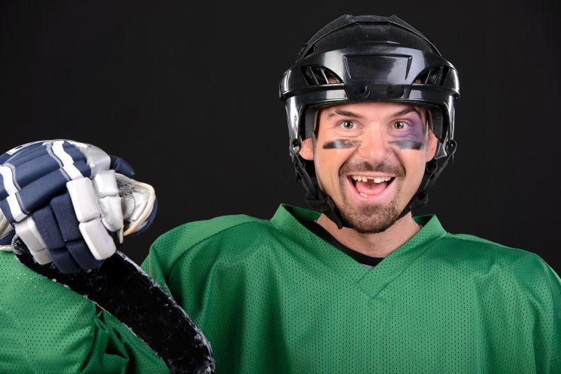 smiling hockey player missing a tooth