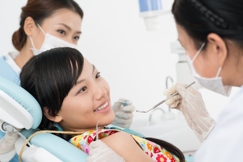 young girl smiling in dental chair 