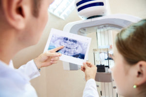 Dentist reviewing X-ray with patient